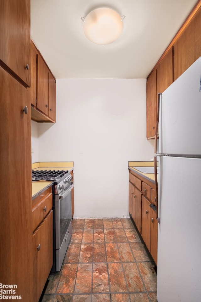 kitchen featuring gas stove and white refrigerator