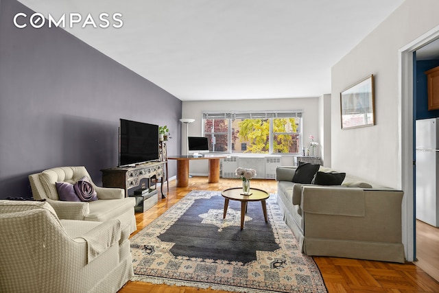 living room with parquet floors and radiator heating unit