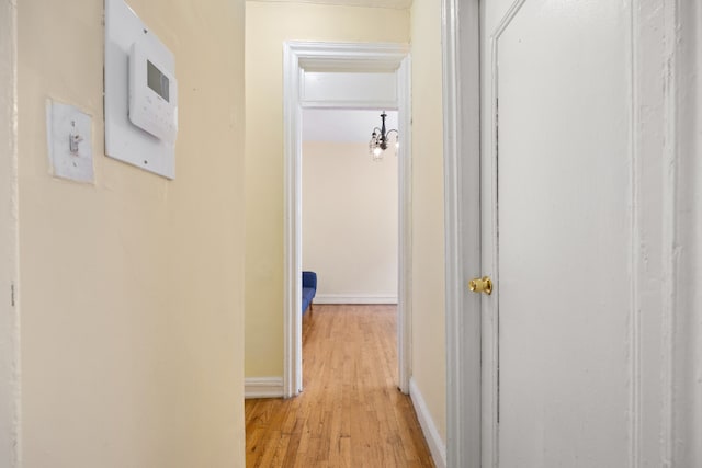 corridor with light hardwood / wood-style floors