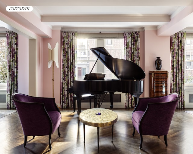 living area featuring beamed ceiling, plenty of natural light, and ornamental molding