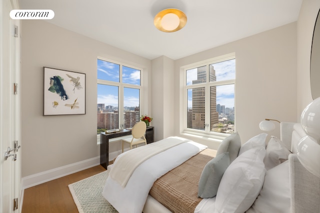 bedroom featuring dark hardwood / wood-style floors and multiple windows