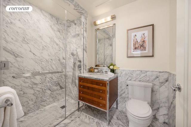 bathroom with vanity, an enclosed shower, tile walls, and toilet