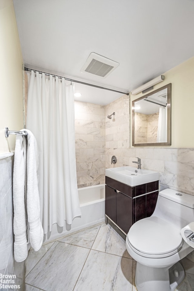 full bathroom featuring shower / tub combo with curtain, vanity, tile walls, and toilet