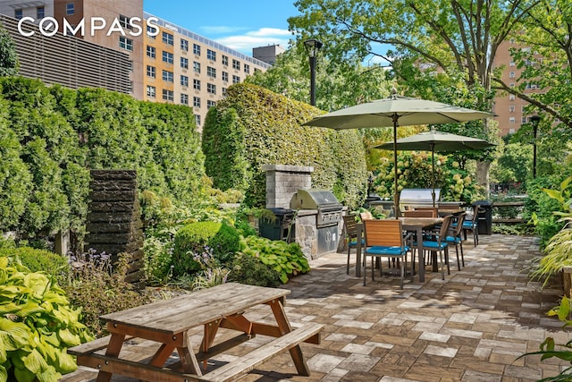 view of patio featuring area for grilling and a grill