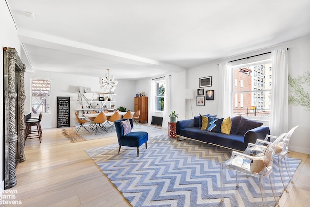 living room featuring a chandelier and wood-type flooring