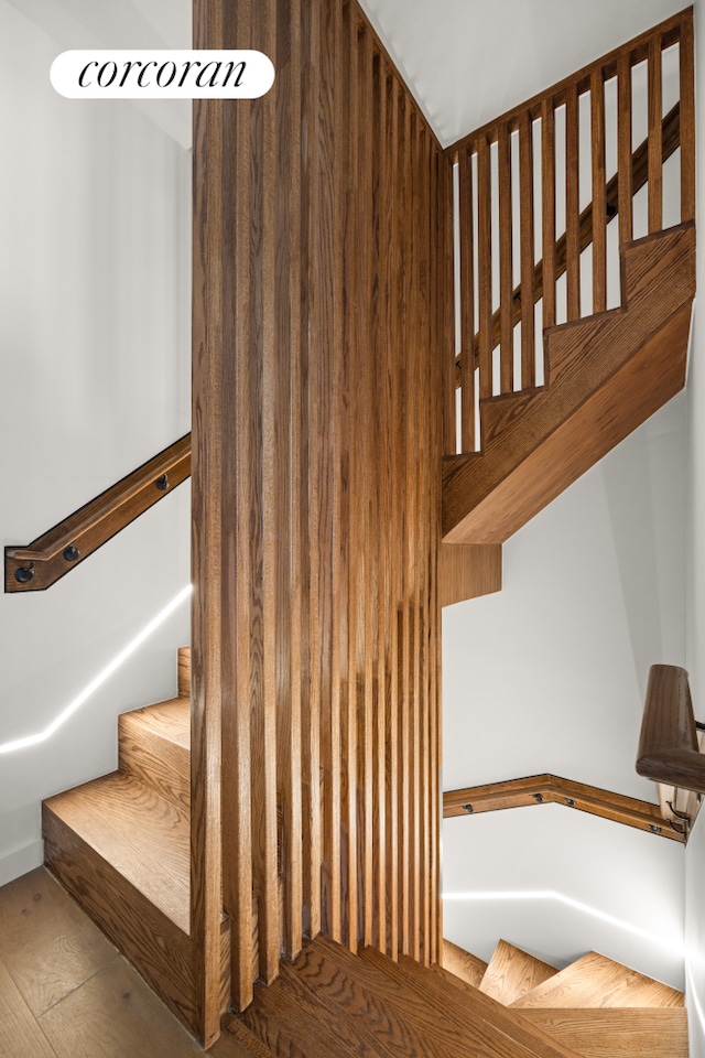 staircase with wood-type flooring