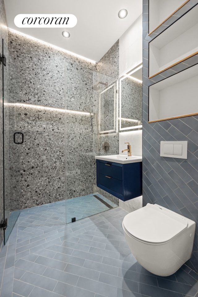 bathroom featuring vanity, tile walls, and tiled shower