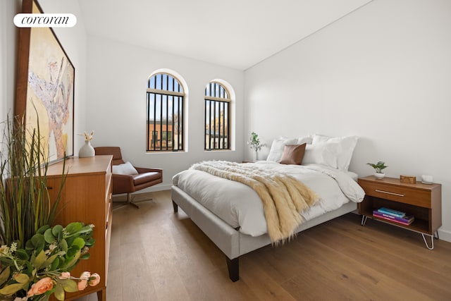 bedroom with hardwood / wood-style flooring and vaulted ceiling