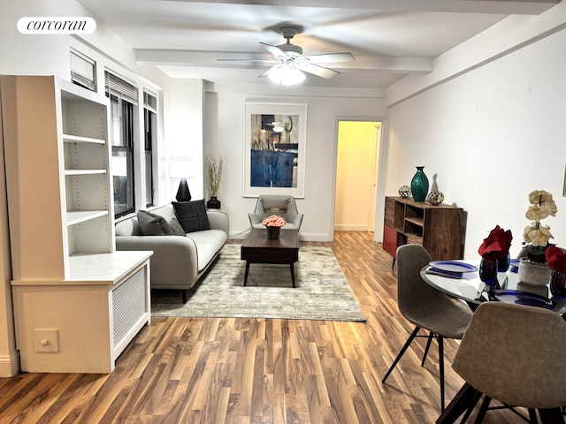 living room with beamed ceiling, hardwood / wood-style flooring, and ceiling fan