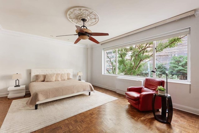 bedroom with ceiling fan, parquet floors, and ornamental molding