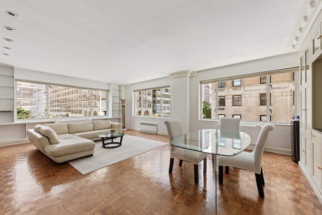 dining area featuring parquet flooring and radiator heating unit