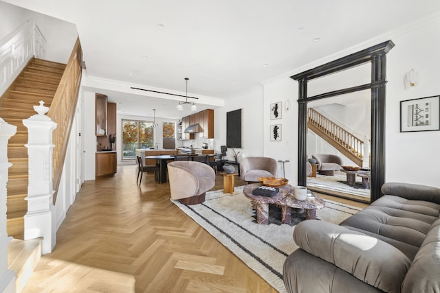 living room with light parquet floors and crown molding