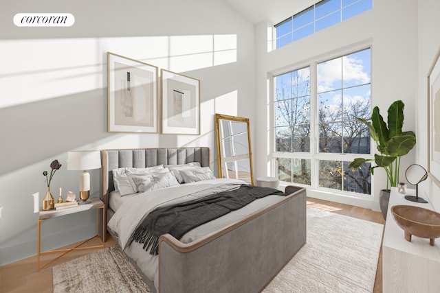 bedroom featuring light hardwood / wood-style flooring and lofted ceiling