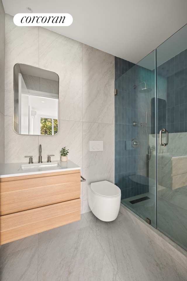 bathroom featuring vanity, toilet, an enclosed shower, and tile walls