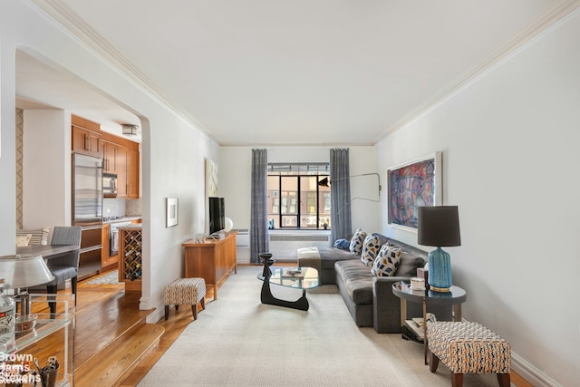 living room featuring light hardwood / wood-style flooring and ornamental molding