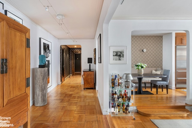 hallway with light parquet flooring and ornamental molding