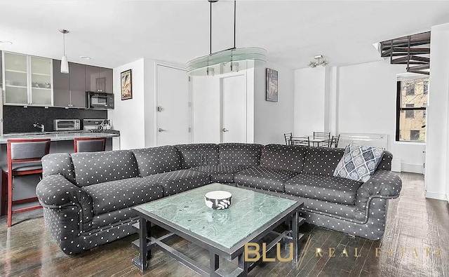 living room with dark hardwood / wood-style floors and breakfast area