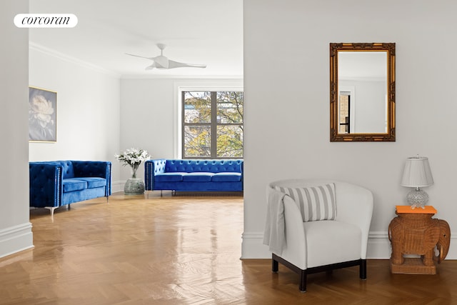 living area featuring ceiling fan, parquet floors, and ornamental molding