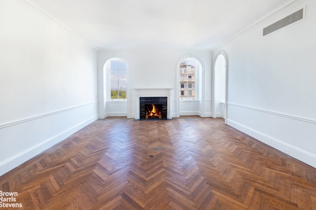 unfurnished living room featuring a fireplace, dark parquet floors, and ornamental molding