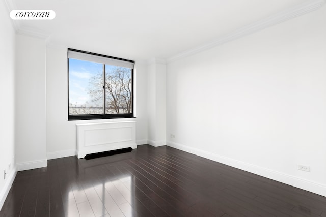 empty room with dark hardwood / wood-style floors and ornamental molding