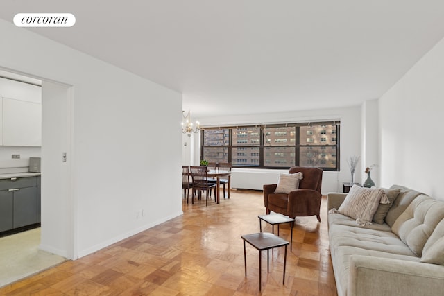 living room with light parquet floors and an inviting chandelier