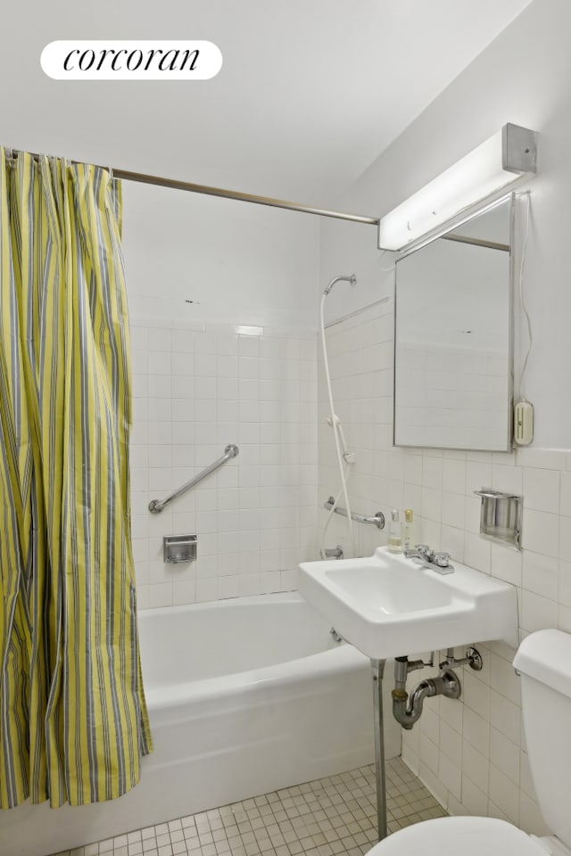 bathroom with shower / tub combo with curtain, tile patterned flooring, tile walls, and toilet