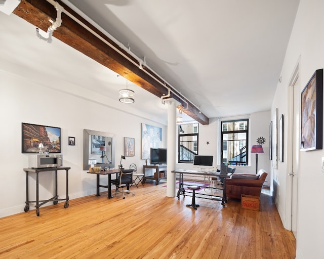 interior space with beamed ceiling and hardwood / wood-style flooring