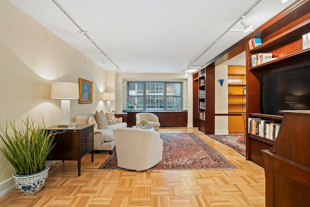 living room featuring light parquet flooring and track lighting