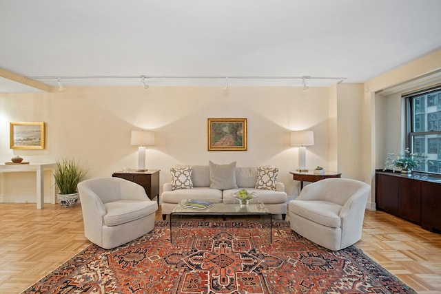 living room with rail lighting and light parquet flooring