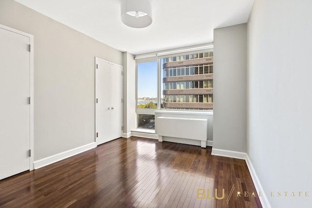 unfurnished room featuring dark hardwood / wood-style floors