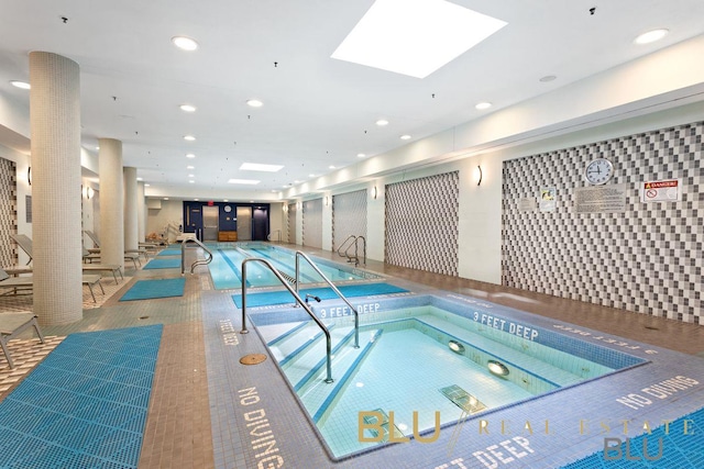 view of swimming pool with a skylight