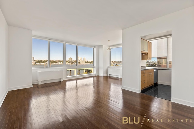 unfurnished room with dark hardwood / wood-style floors and a notable chandelier