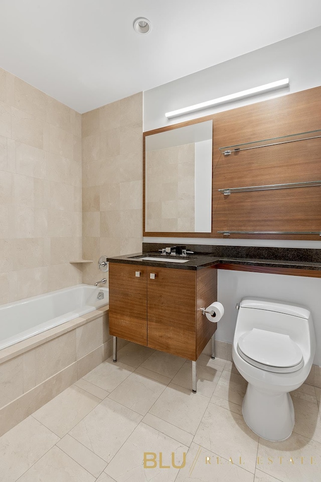 bathroom featuring tile patterned floors, vanity, tile walls, and toilet