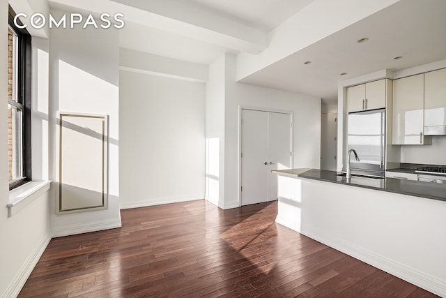 kitchen featuring beamed ceiling, refrigerator, dark hardwood / wood-style floors, and sink