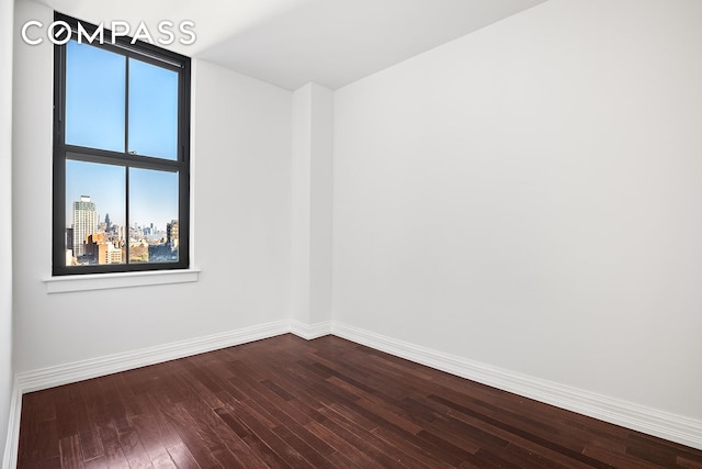 unfurnished room with wood-type flooring