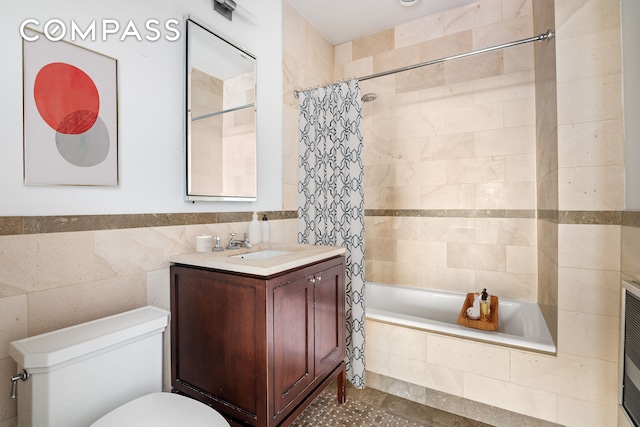 full bathroom with shower / tub combo, vanity, toilet, and tile walls