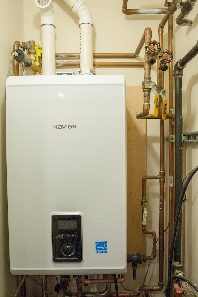 utility room featuring tankless water heater