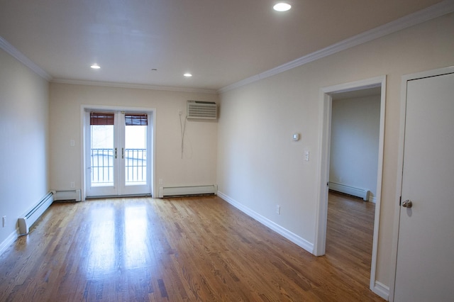 empty room with hardwood / wood-style floors, french doors, a baseboard radiator, and ornamental molding