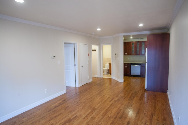 unfurnished living room featuring crown molding and dark hardwood / wood-style floors