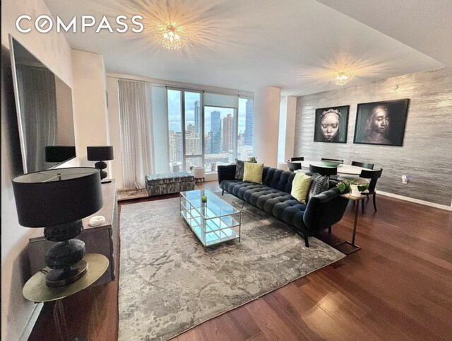 living room featuring floor to ceiling windows and hardwood / wood-style floors