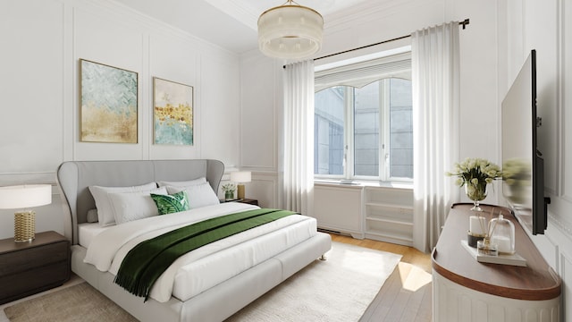 bedroom featuring light hardwood / wood-style floors and ornamental molding