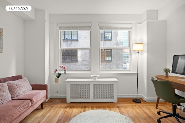 interior space featuring light wood-type flooring and radiator heating unit