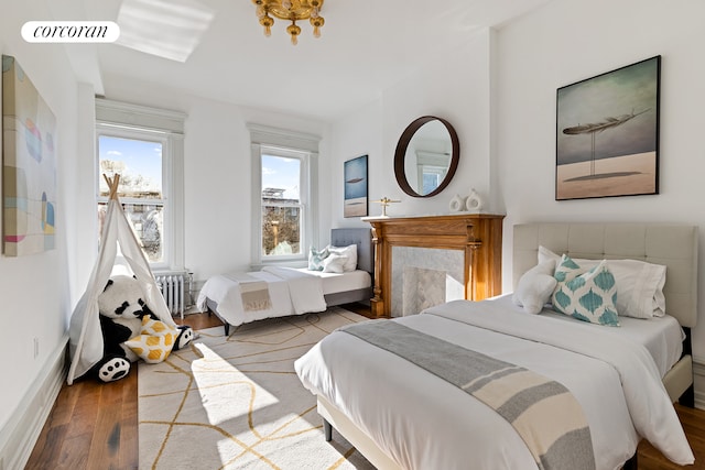 bedroom featuring hardwood / wood-style floors and radiator