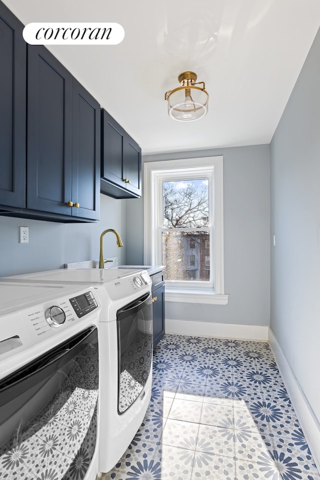 laundry area featuring washer and dryer, light tile patterned flooring, cabinets, and sink