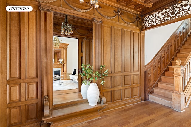 interior space featuring hardwood / wood-style floors, wooden ceiling, crown molding, and coffered ceiling