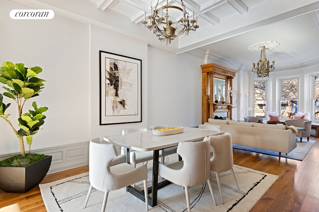 dining space featuring beam ceiling, hardwood / wood-style flooring, an inviting chandelier, and coffered ceiling