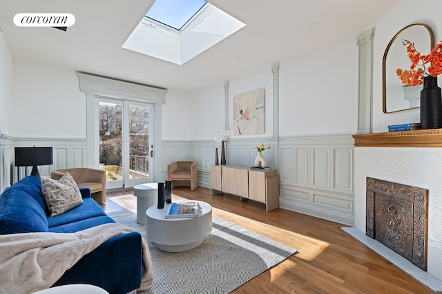 living room featuring a skylight and wood-type flooring