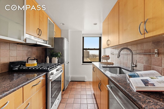 kitchen with ventilation hood, sink, dark stone countertops, light tile patterned floors, and stainless steel appliances