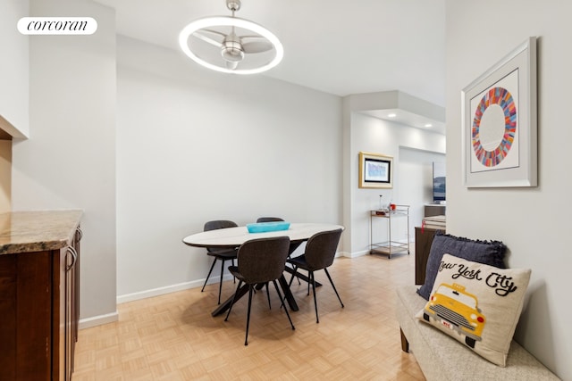 dining room with light parquet floors and ceiling fan