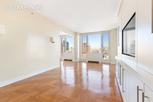 unfurnished living room with light parquet flooring